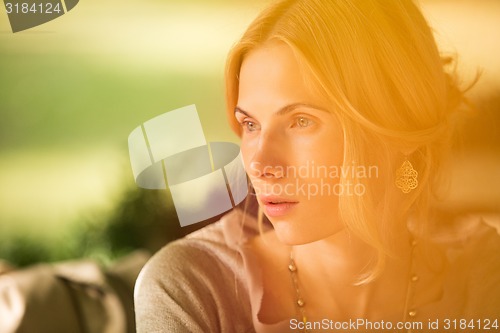 Image of portrait of a beautiful young woman in park.