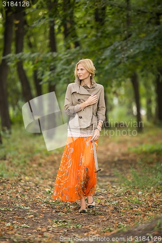 Image of Young woman walking in forest