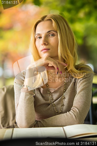 Image of portrait of a beautiful young woman in park.