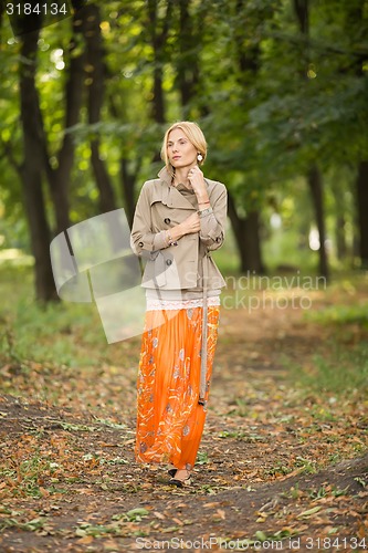 Image of Young woman walking in forest