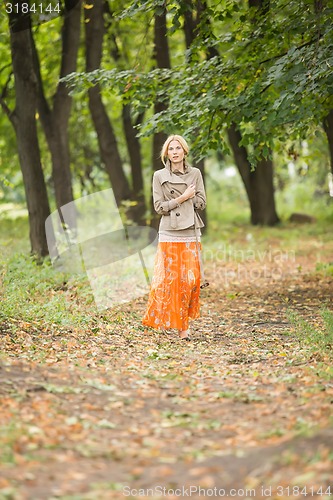 Image of Young woman walking in forest