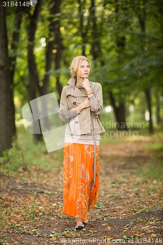 Image of Young woman walking in forest