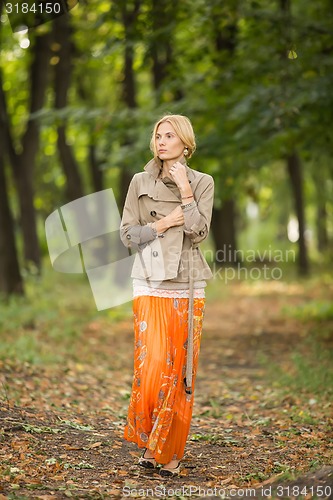 Image of Young woman walking in forest