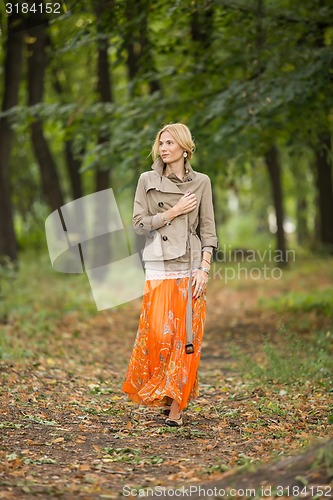 Image of Young woman walking in forest
