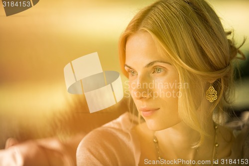 Image of portrait of a beautiful young woman in park.