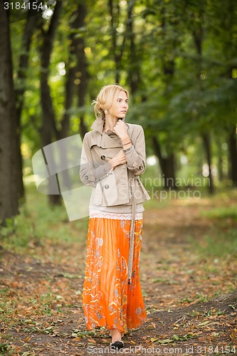 Image of Young woman walking in forest