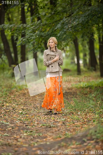 Image of Young woman walking in forest