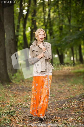 Image of Young woman walking in forest