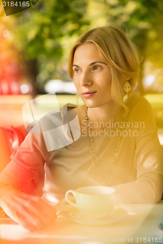 Image of portrait of a beautiful young woman in park.