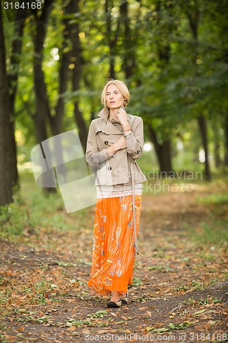 Image of Young woman walking in forest