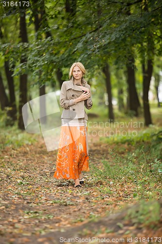 Image of Young woman walking in forest