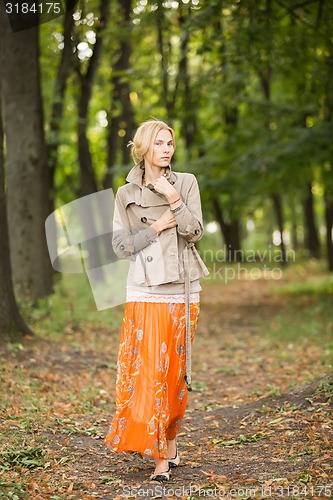 Image of Young woman walking in forest