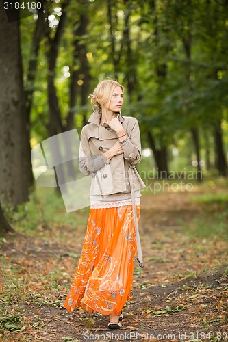 Image of Young woman walking in forest