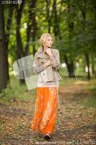 Image of Young woman walking in forest