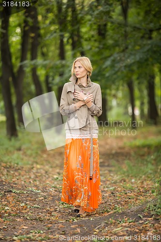 Image of Young woman walking in forest