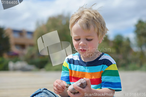 Image of Happy little boy in multicolored t-shirt