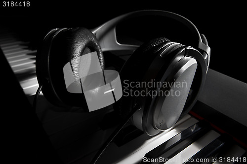 Image of Piano keyboard with headphones