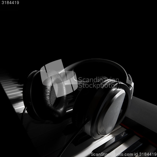 Image of Piano keyboard with headphones