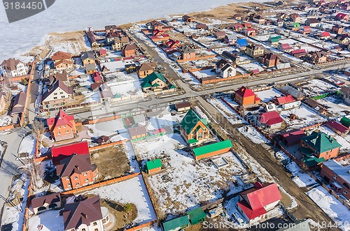 Image of Aerial view on suburban street near lake at spring