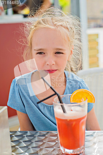 Image of Little girl drinking orange juice