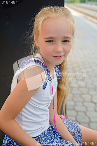 Image of Little girl sitting on the bench