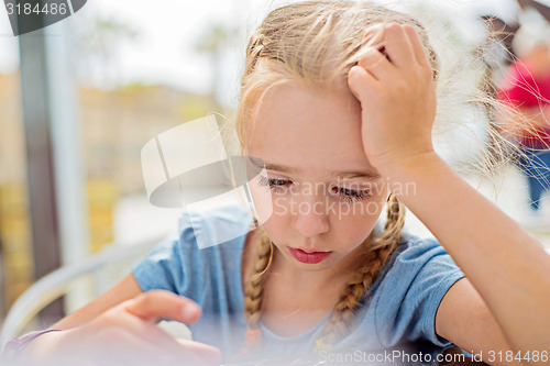 Image of Little girl sitting outdoor