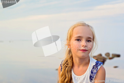 Image of Portrait of little cute girl on sunset