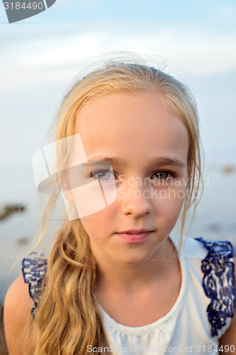 Image of Portrait of little cute girl on sunset