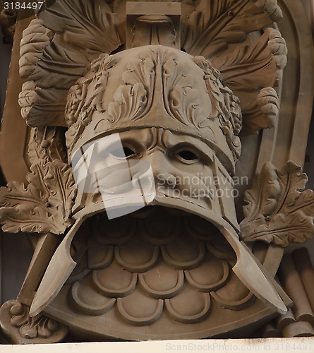 Image of military heraldic mask bas relief