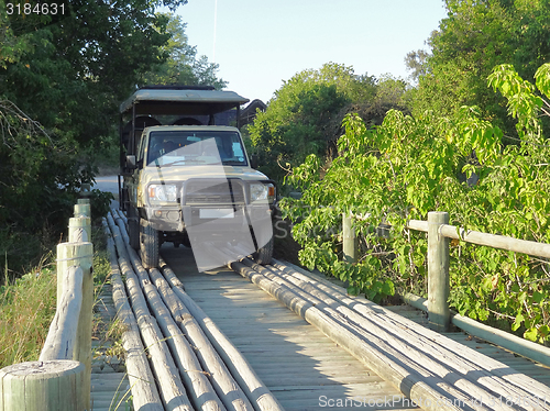 Image of off-road vehicle on wooden bridge