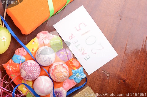 Image of Easter setting with gift box and spring decoration