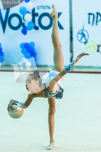 Image of Young pretty girl shows exercise with ball