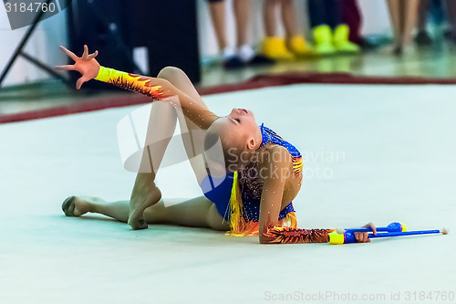 Image of Young girl shows exercise with maces