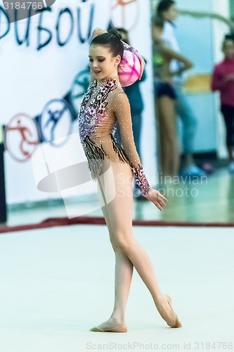 Image of Young pretty girl shows exercise with ball