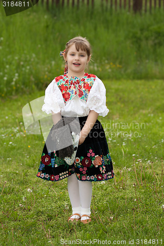 Image of Little girl playing on a meadow