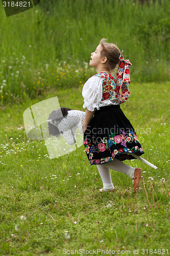Image of Little girl playing on a meadow