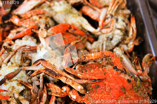 Image of Grilled crab on flaming grill. 