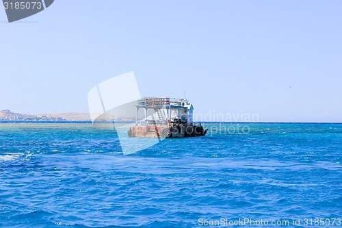 Image of Old Rusty Barge floating on the Sea