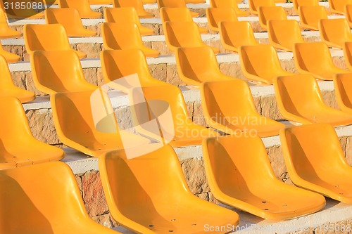Image of Stadium Yellow Chairs at sun light.