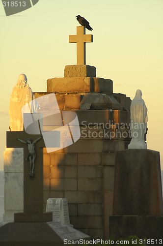 Image of crow on tomb cross