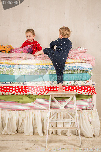 Image of Children on the bed - Princess and the Pea.