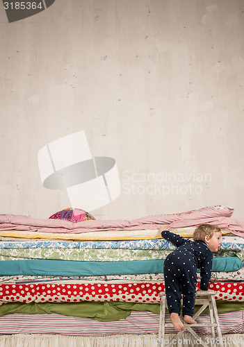 Image of Child climbs on the bed - Princess and the Pea.