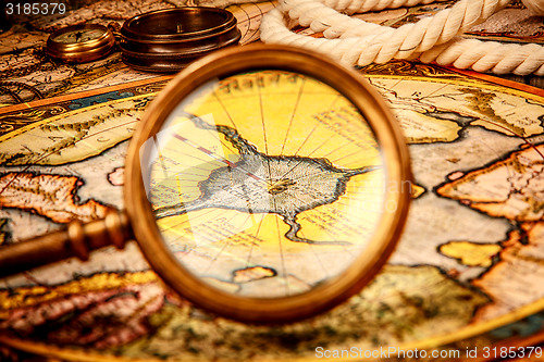 Image of Vintage magnifying glass lies on the ancient map of the North Po