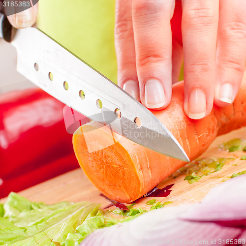 Image of Woman\'s hands cutting vegetables