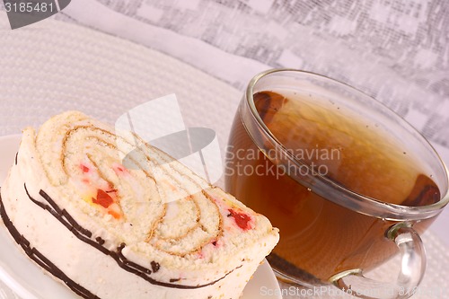 Image of cup of tea and some cookies on white material background