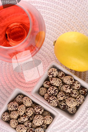 Image of sweet cake on white plate, red wine and fruits