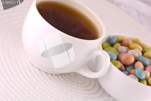 Image of A cup of tea (coffee) and candies