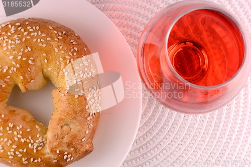 Image of chocolate sweet cake on white plate and red wine