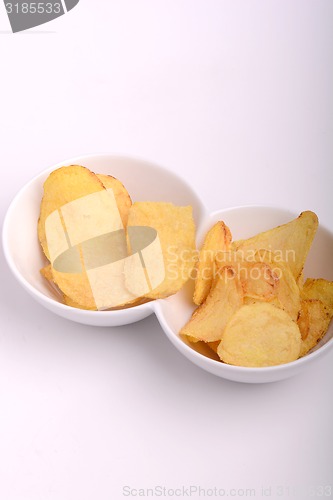 Image of Potato chips on white bowl, close up