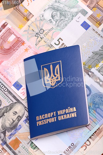 Image of ukrainian passport with euro notes and american dollars